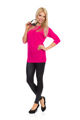 Fototapeta premium Beautiful Woman Is Smiling And Biting Sunglasses