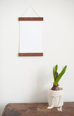 Light white frame on a white wall and flower