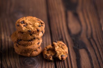 Chocolate chips cookies on dark brown wooden background