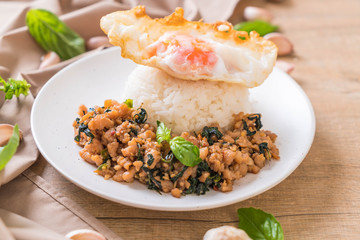 stir-fried pork with basil  on rice and fried egg