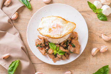 stir-fried pork with basil  on rice and fried egg