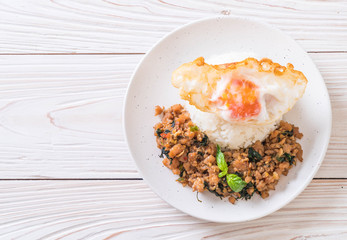 stir-fried pork with basil  on rice and fried egg