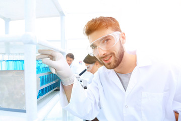 Fototapeta premium A young man doing an experiment in a chemical laboratory