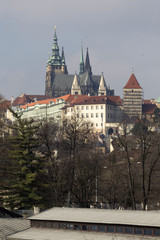 Obraz premium Early Spring Prague gothic Castle with the Lesser Town above River Vltava in the sunny Day, Czech Republic