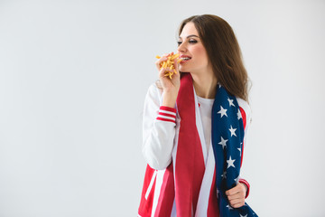 sexy smiling girl with usa flag eating french fries isolated on white