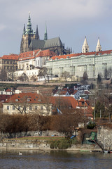 Obraz premium Early Spring Prague gothic Castle with the Lesser Town above River Vltava in the sunny Day, Czech Republic