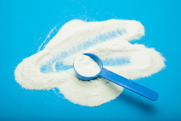 Milk powder for baby in measuring spoon.