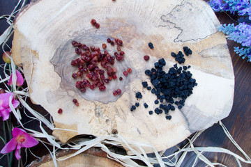 Blueberries and cranberries on wooden board with pattern
