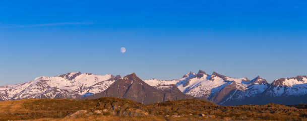 Panoramic Shot Of Beautiful Sunset / Midnight Sun Scene, Mountain With Snow, Lofoten Islands, Norway