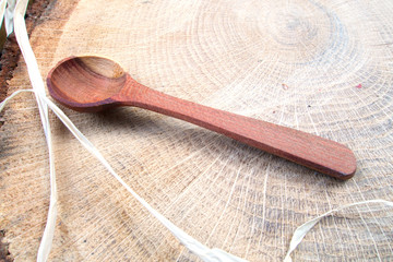 Nice wooden spoon on slice of tree stool