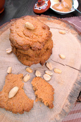 Sweet healthy peanut cookies on wooden table with honey