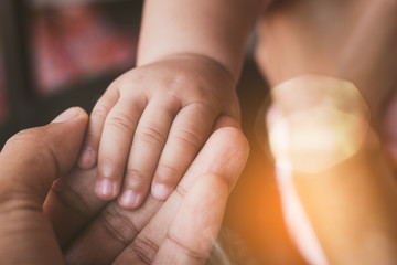 new born baby 's hand in mother 's hand full with love and care.