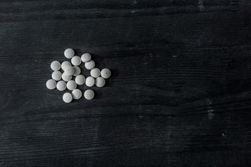 top view of mdma pills on black wooden surface