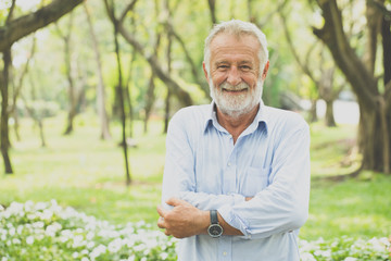 Portrait of surprised elderly man be smile in park