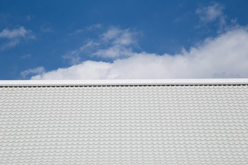 White roof with the cloudy blue sky