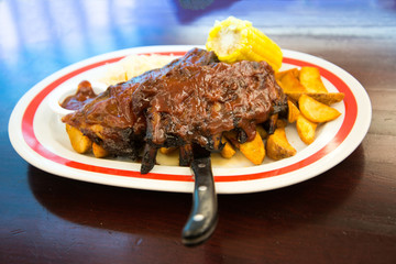 Grilled steak - Grilled meat ribs on the plate with hot sauce