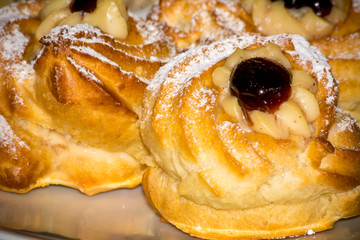 Horizontal View of Traditional Baked Italian Food Called Zeppole Made With Eggs, Cherries and Flour during Saint Joseph Celebration