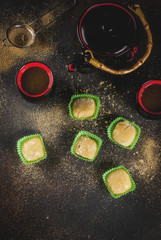 Obraz na płótnie Canvas Matcha tea with green mochi, dark rusty background. Copy space top view