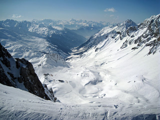 Vertigo inducing view taken from a snowy cliff edge on a crystal clear day in St Anton in the...