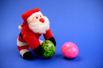 little santa claus with and pink easter egg