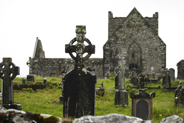 Old graves with the stone cross on the historic Ireland cemetery