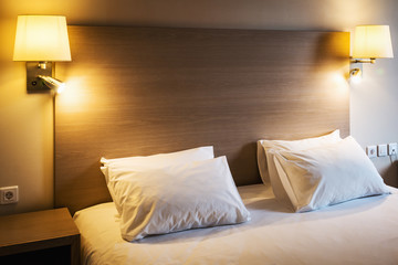 Pillows on a large king-size bed. Concept on preparation of the bed in a hotel room or at home