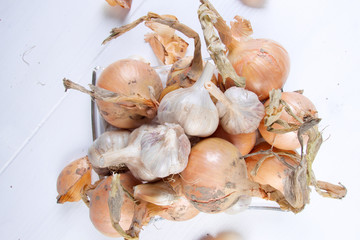 Group of onions and garlics on wooden table