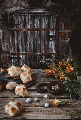 Easter table with hot cross buns and flowers