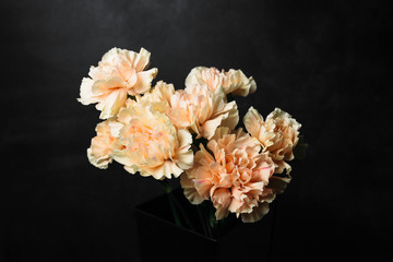 flower Ikibana on a black background, bouquet in a glass vase