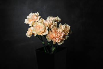 flower Ikibana on a black background, bouquet in a glass vase