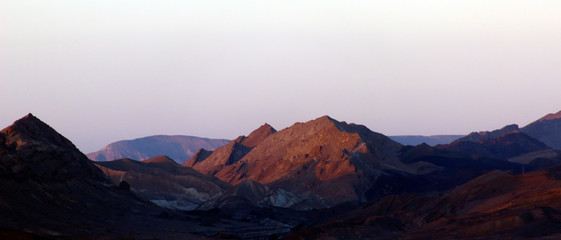 Fototapeta na wymiar Mountains in the desert at sunrise sunset