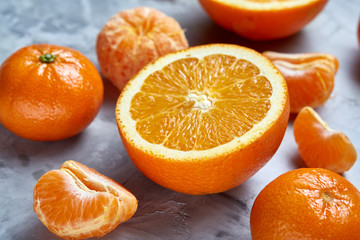 Variety of fresh citrus fruits for making juice or smoothie over light textured background, top view, selective focus.