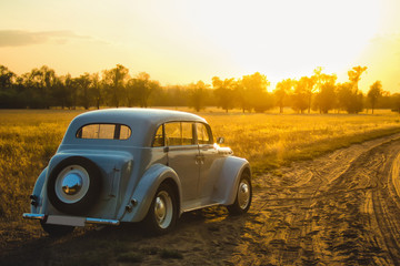 Fototapeta na wymiar car at sunset in the field
