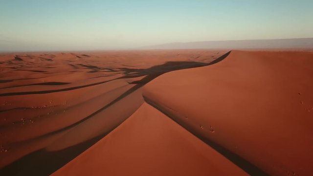 Aerial view on sand dunes in Sahara desert at sunrise, Africa, 4k

