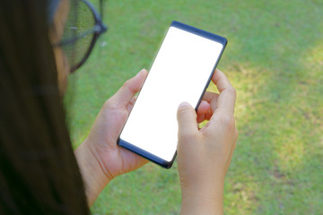 Female hand holding the smartphone Black and Green nature