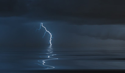 lightning bolts reflection over the sea. taken during a thunderstorm over the ocean with clouds in...