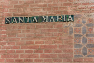 Fototapeta na wymiar Santa Maria ceramic tile sign on a brick wall