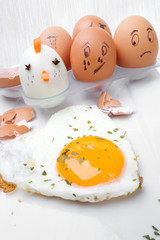 Funny egg faces with daring of sad emotions afraid of cooking