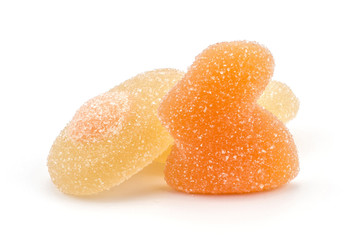 Orange Easter jelly bunny with two lemon eggs isolated on white background two marmalade sweets.