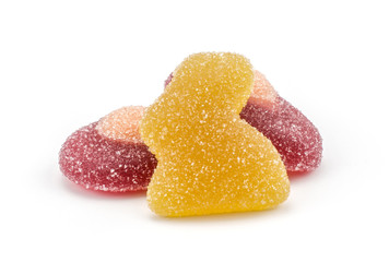 Lemon Easter jelly bunny with two crimson eggs isolated on white background two marmalade sweets.