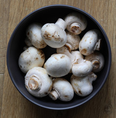 white button Common mushroom (Agaricus bisporus) on wooden table background