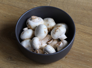 white button Common mushroom (Agaricus bisporus) on wooden table background