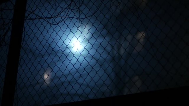 background for horror, industrial  metal fencing against lantern in fog