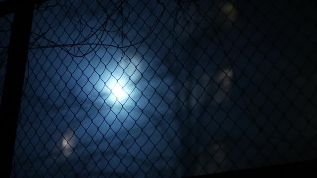 background for horror, industrial  metal fencing against lantern in fog