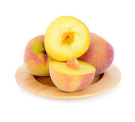 Peach in wood plate isolated on a white background