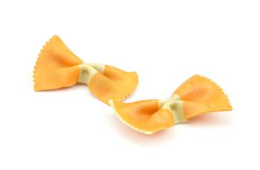 Farfalle pasta with orange carrot isolated on white background two raw classic traditional Italian.