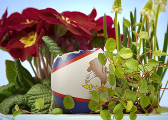 The flag of American Samoa on an cracked egg in a floral scene.(series)