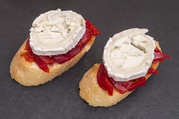 canape of peppers with cheese on black background