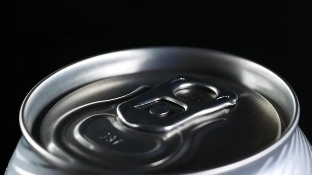 A cold drink rotates against a black background