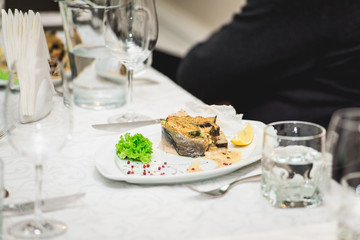 portion of delicious fish fillet in sauce at the restaurant. small portion